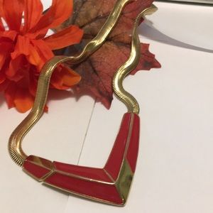 Necklace gold and red arrow design.